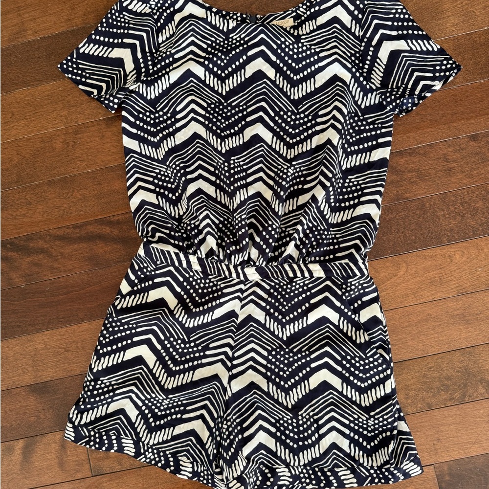 NWOT JCrew romper with pockets. 100% polyester, zipper back and clasp detail.